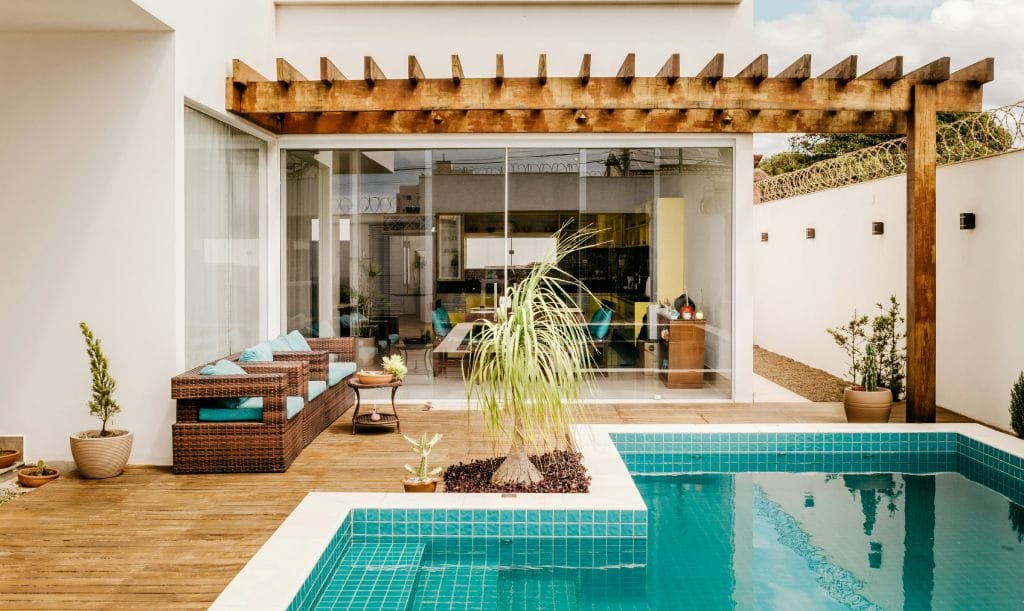 outdoor patio with a pool and a pergola