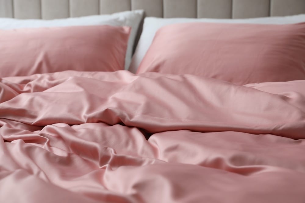 Bed with beautiful pink silk linens